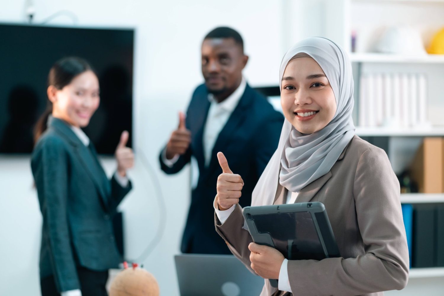 Startup team celebrating in their office after receiving a government innovation grant.